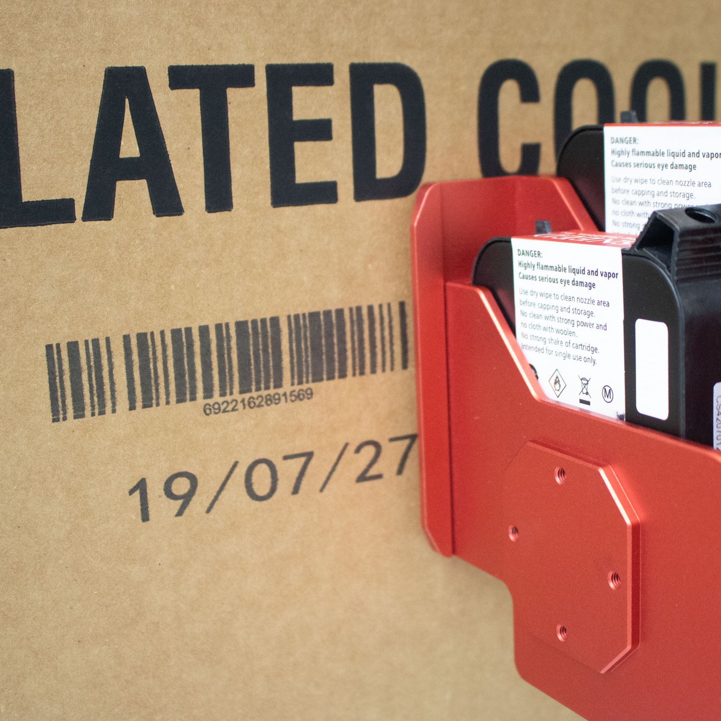 Close-up of SNEEDJET Freedom 21 print head with dual ink cartridges printing barcode and expiration date on cardboard