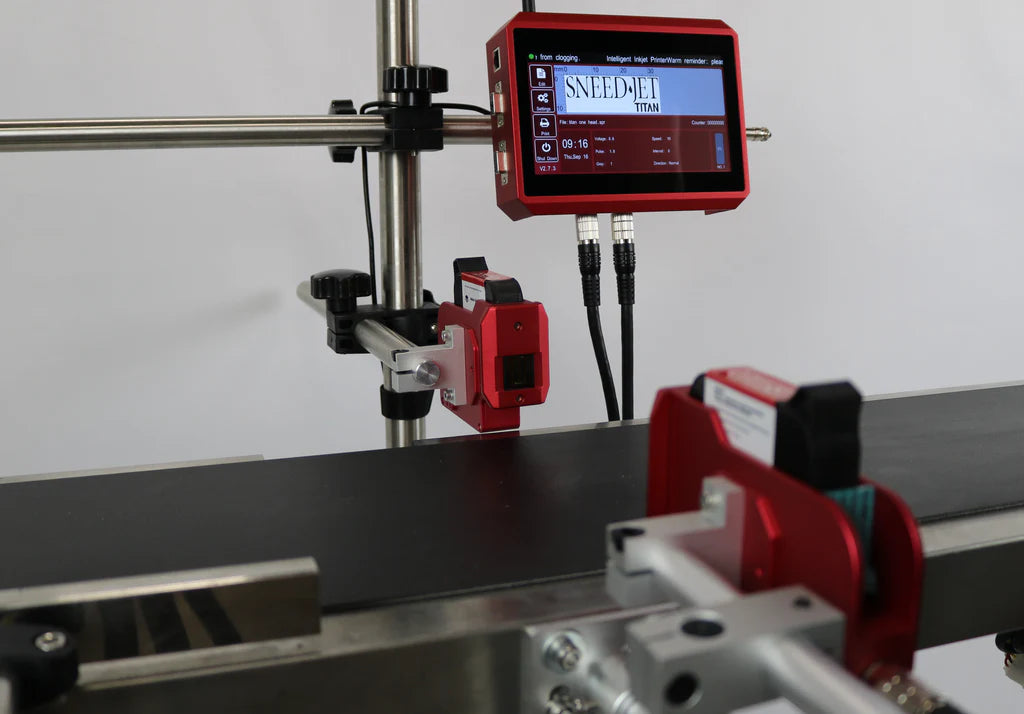SNEED-JET Titan thermal inkjet printer mounted above a conveyor with touchscreen controller and dual print heads